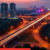 Aerial panorama of Sonipat’s new expressway, rapid‑rail line, residential high‑rises, and industrial hub illustrating emerging smart‑city growth.